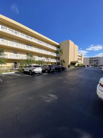 a view of a street with a car parked on the road