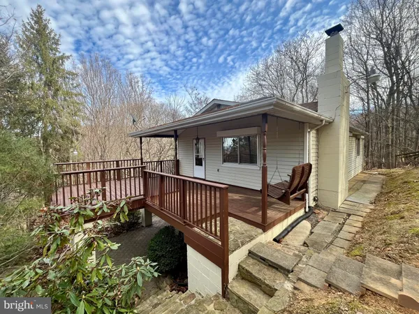 a view of a house with wooden fence in a backyard