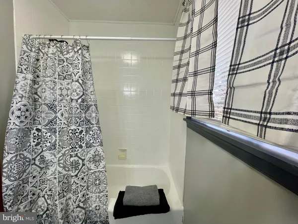 a bathroom with a bathtub and shower