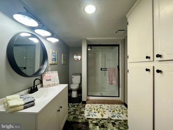 a bathroom with a mirror a sink and a mirror