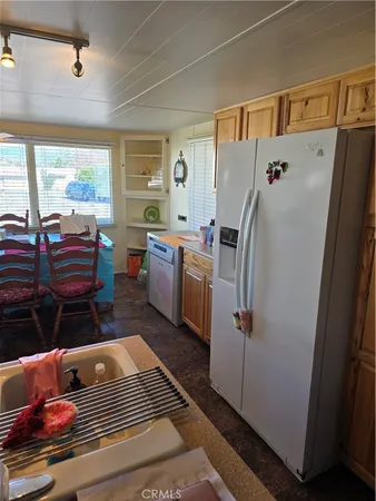a kitchen with stainless steel appliances granite countertop a refrigerator and a stove