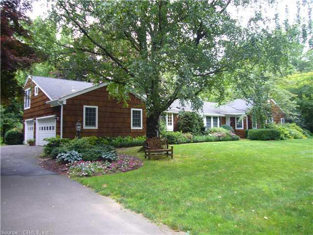 a front view of a house with a garden and porch