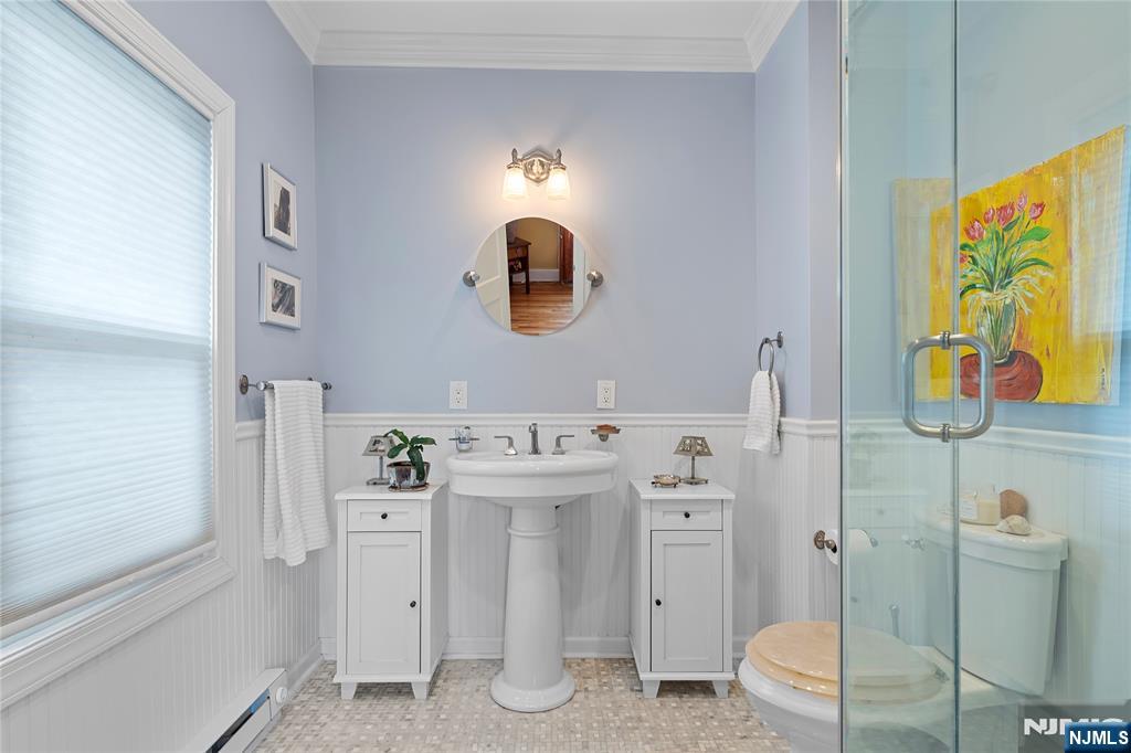 5 Leo Terrace Bloomfield, NJ 07003 - Photo 16 of 32 a bathroom with a sink mirror vanity and toilet
