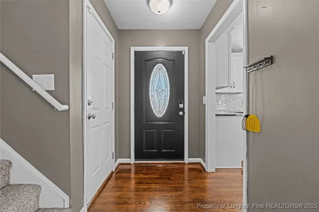 a view of an entryway with wooden floor