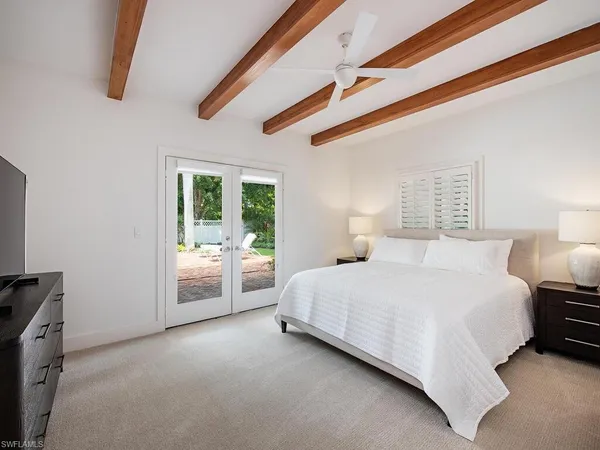 a spacious bedroom with a bed and a cabinets