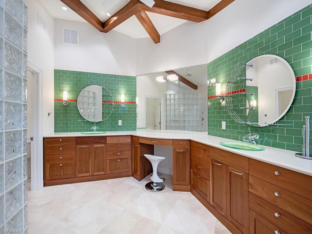 195 2nd Avenue North Naples, FL 34102 - Photo 23 of 26 a room with a sink and mirror