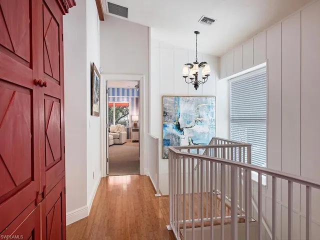 a bedroom with bed and large windows