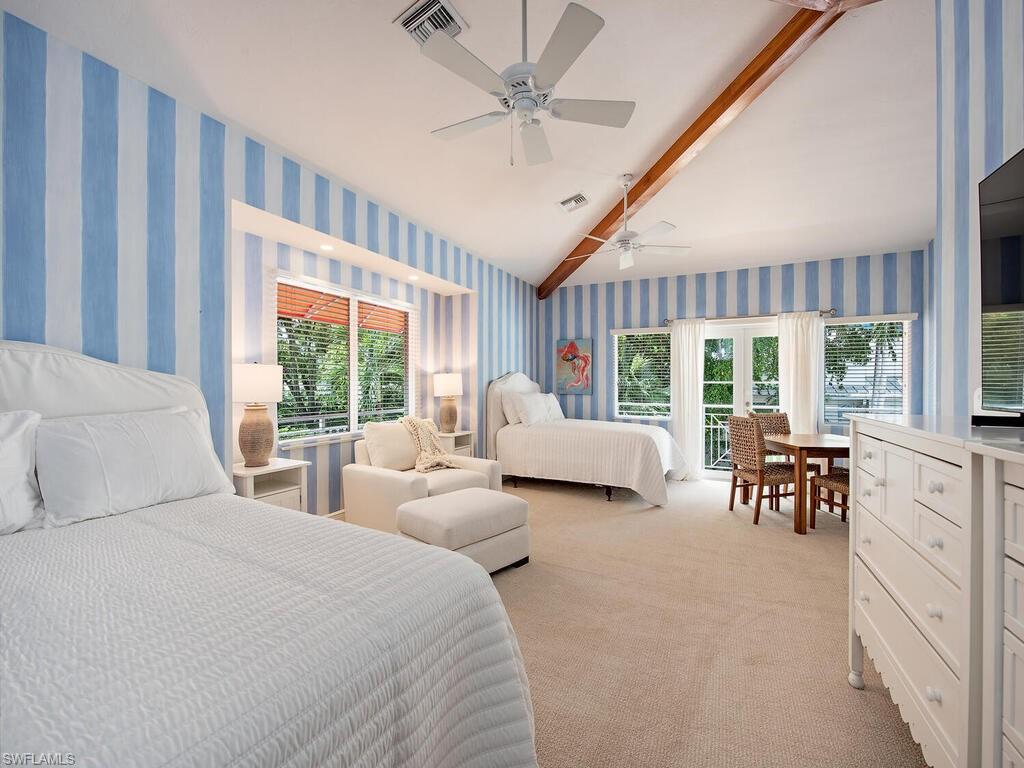 195 2nd Avenue North Naples, FL 34102 - Photo 25 of 26 a bedroom with bed and large windows