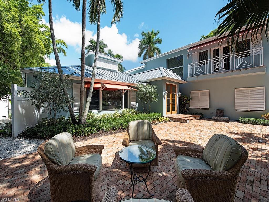 195 2nd Avenue North Naples, FL 34102 - Photo 4 of 26 a patio with couches and a fire pit