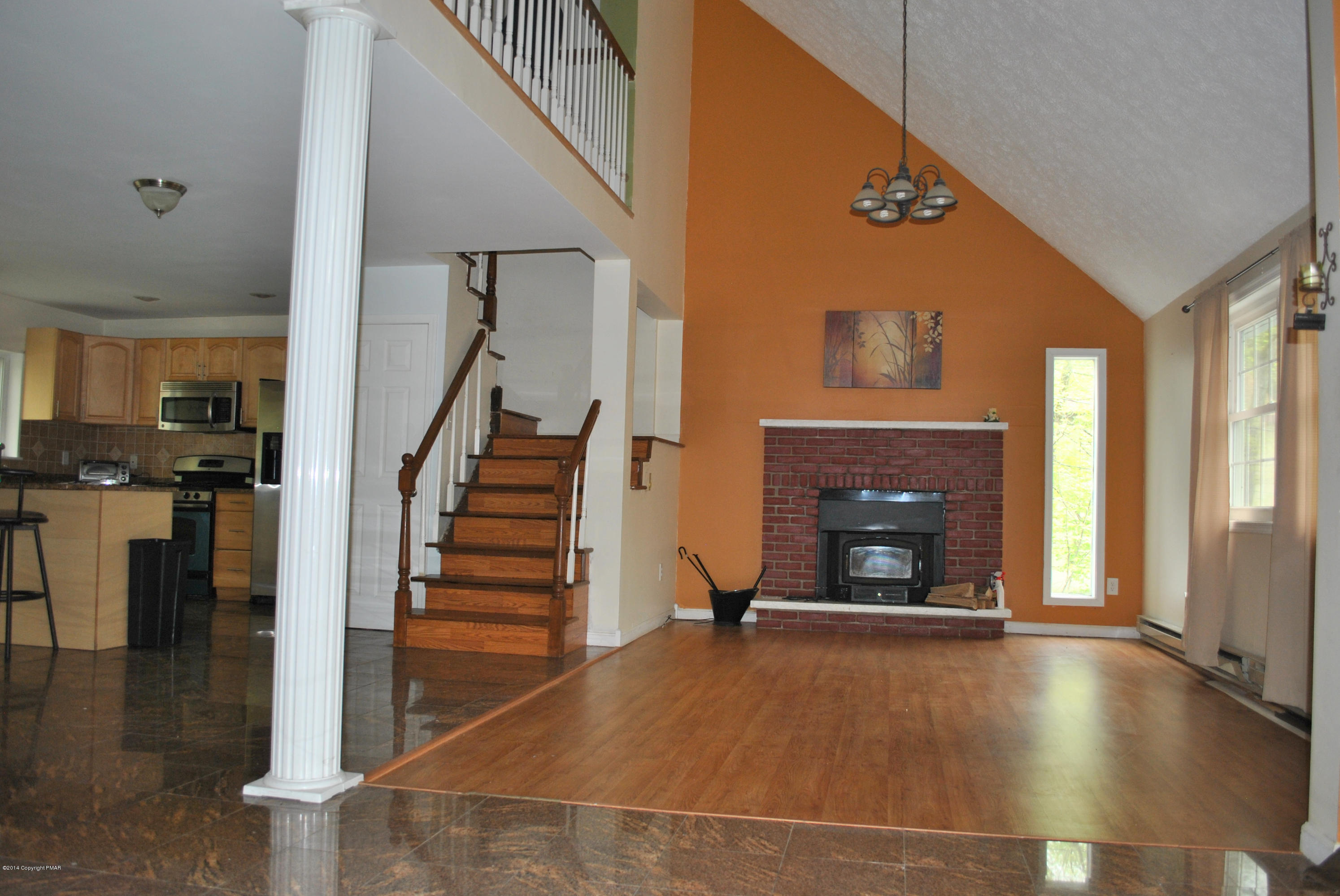 6165 Decker Road Bushkill, PA 18324 - Photo 5 of 16 a view of an empty room with wooden floor fireplace and windows