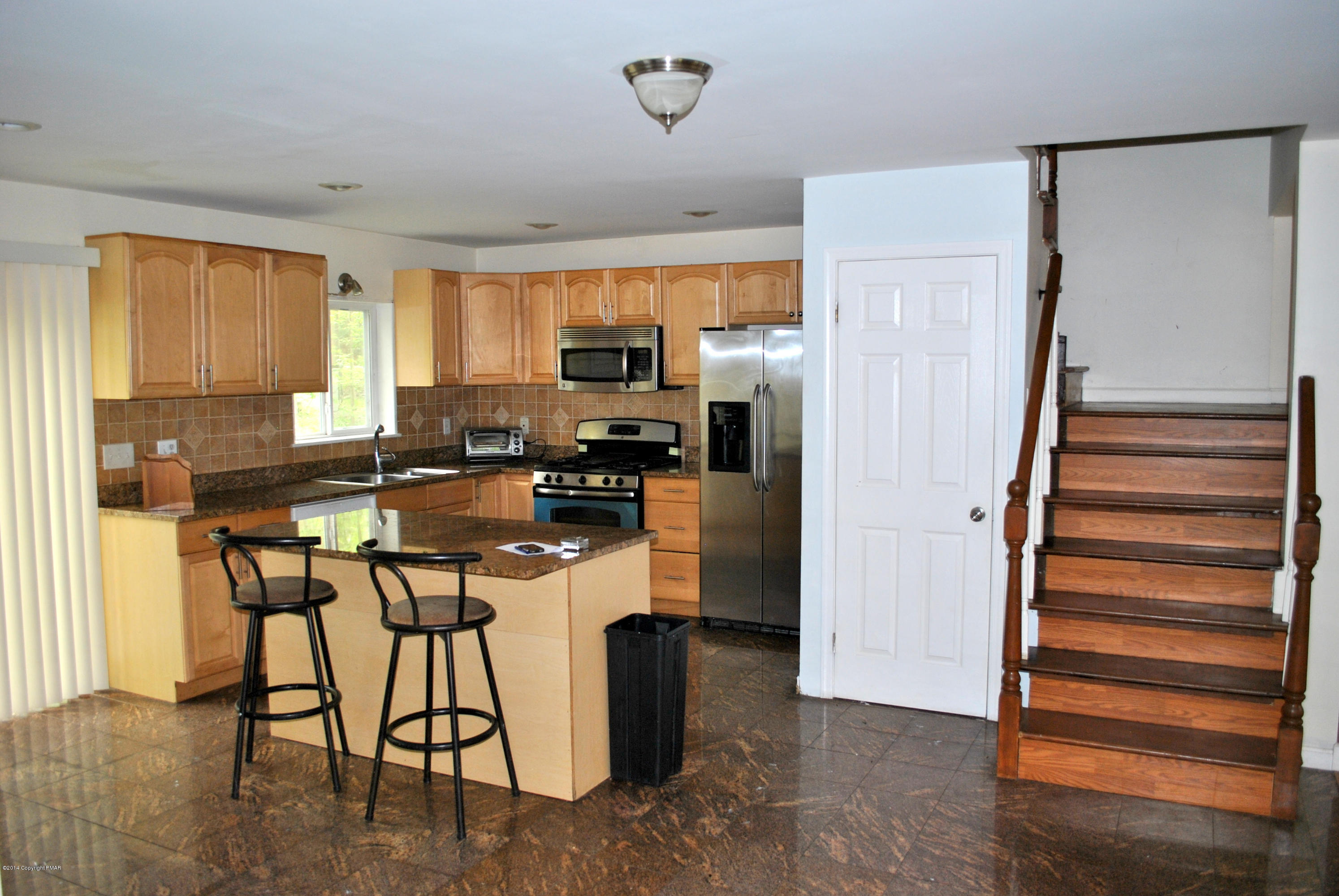 6165 Decker Road Bushkill, PA 18324 - Photo 7 of 16 a kitchen with stainless steel appliances granite countertop a stove a refrigerator and a refrigerator with wooden floor