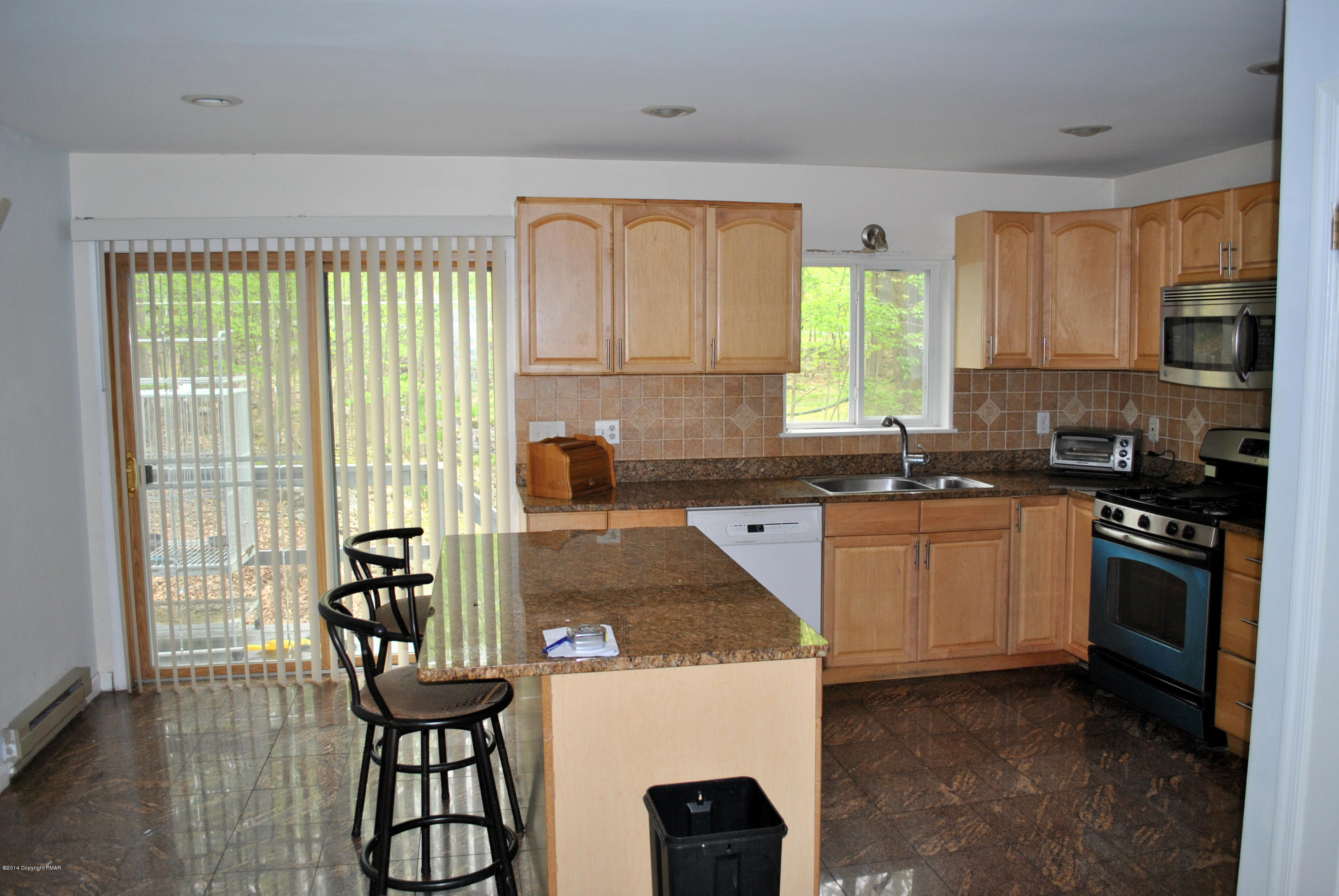 6165 Decker Road Bushkill, PA 18324 - Photo 8 of 16 a kitchen with a stove a sink and a refrigerator