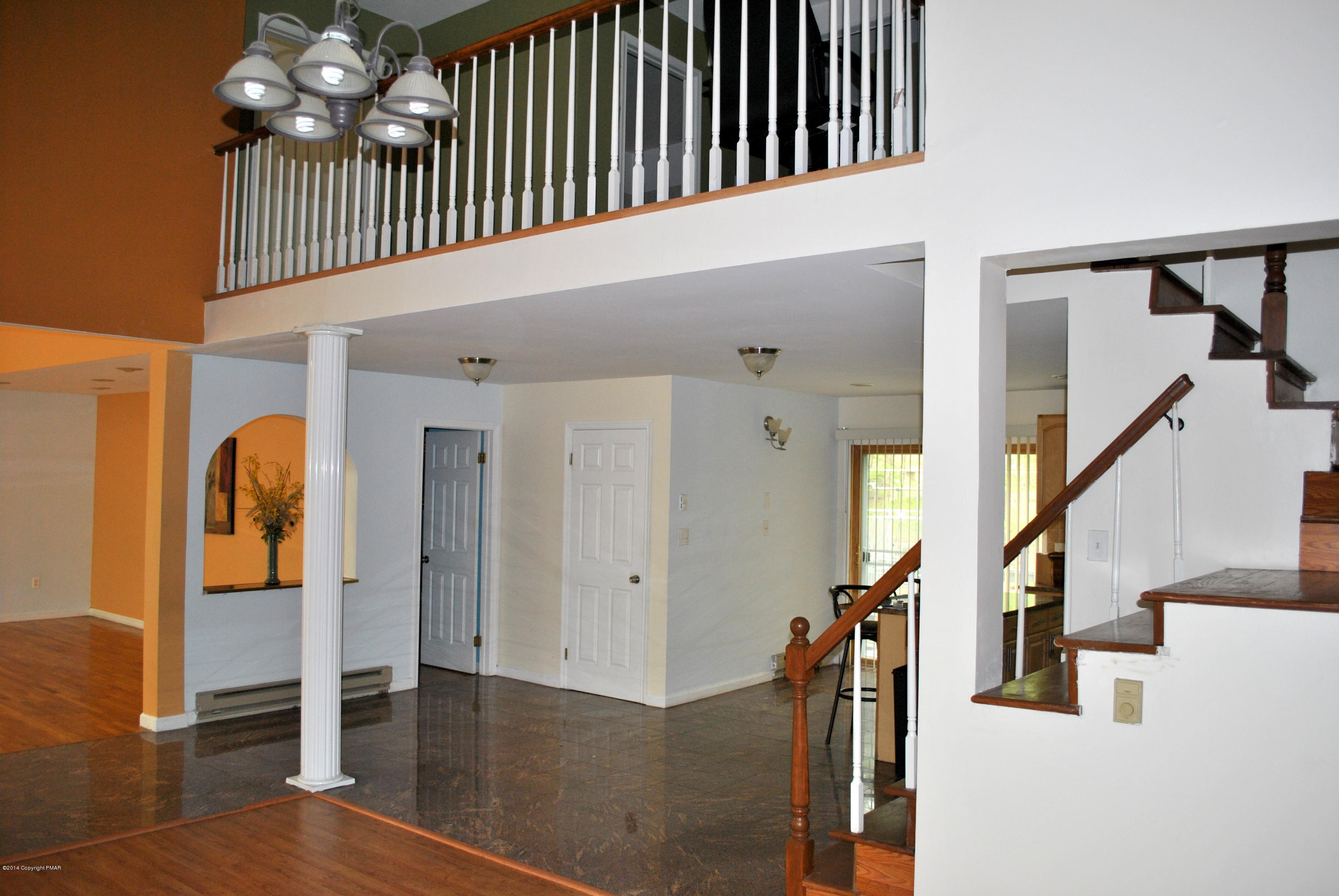 6165 Decker Road Bushkill, PA 18324 - Photo 10 of 16 a view of staircase with railing and a chandelier
