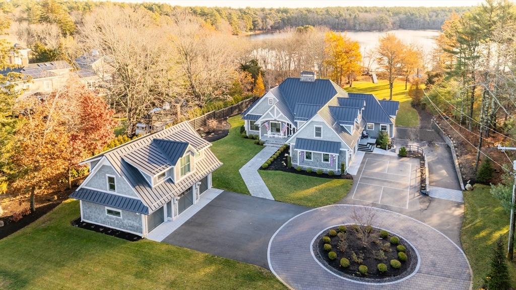 an aerial view of a house with swimming pool and ocean view