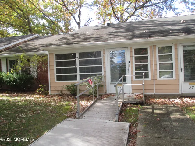 front view of a house with a large window and a yard