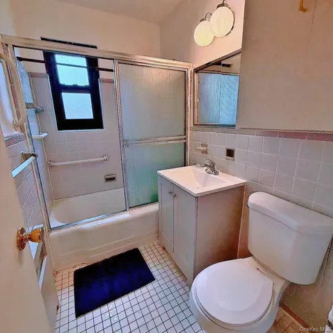 a bathroom with a sink a toilet a mirror and shower