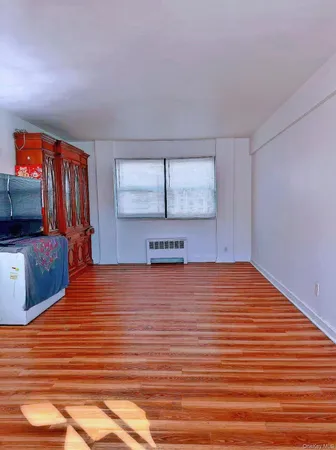 a room with a bed and a flat screen tv