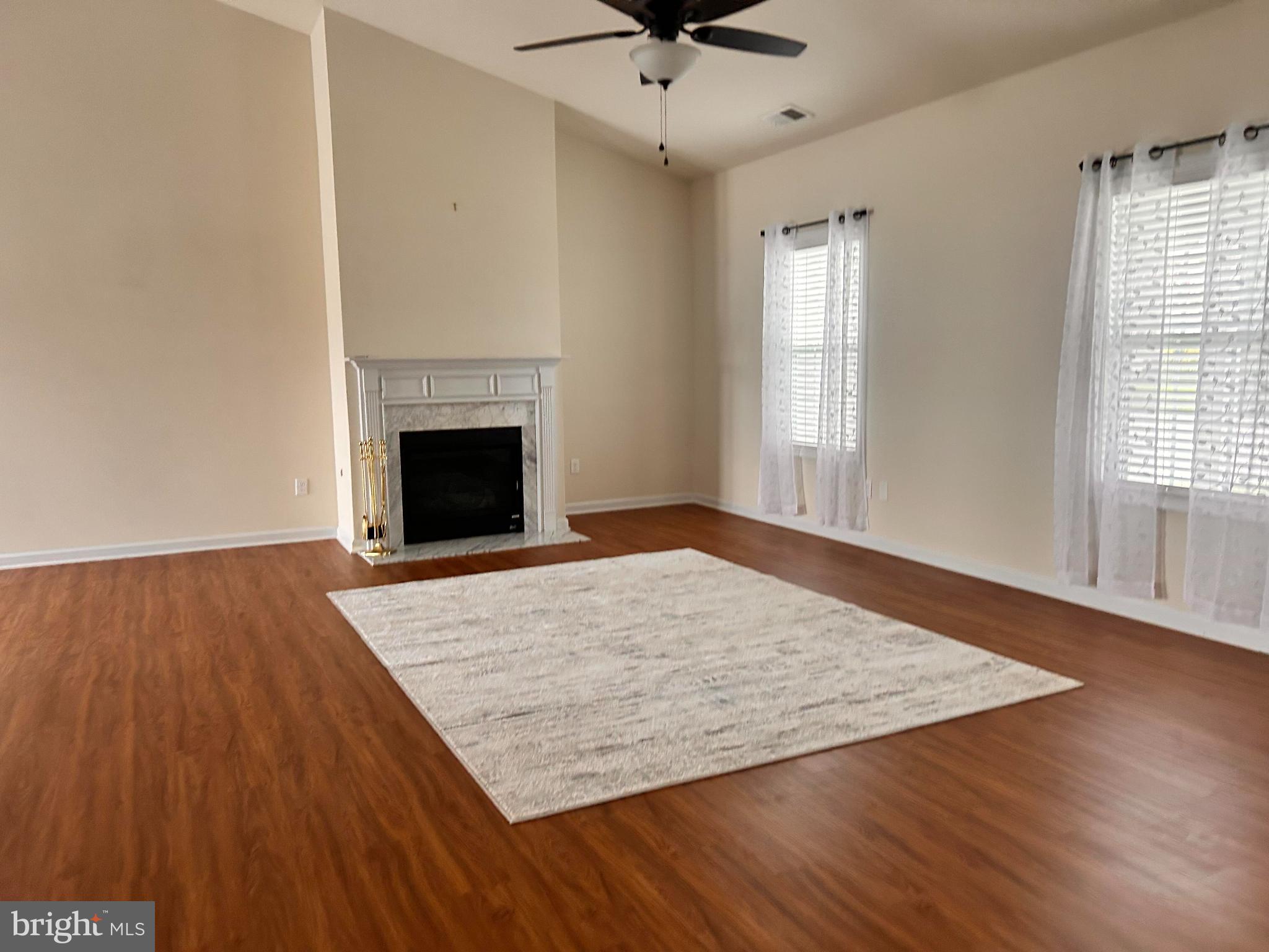 52 Harness Race Road Martinsburg, WV 25404 - Photo 4 of 16 an empty room with wooden floor a fireplace and windows