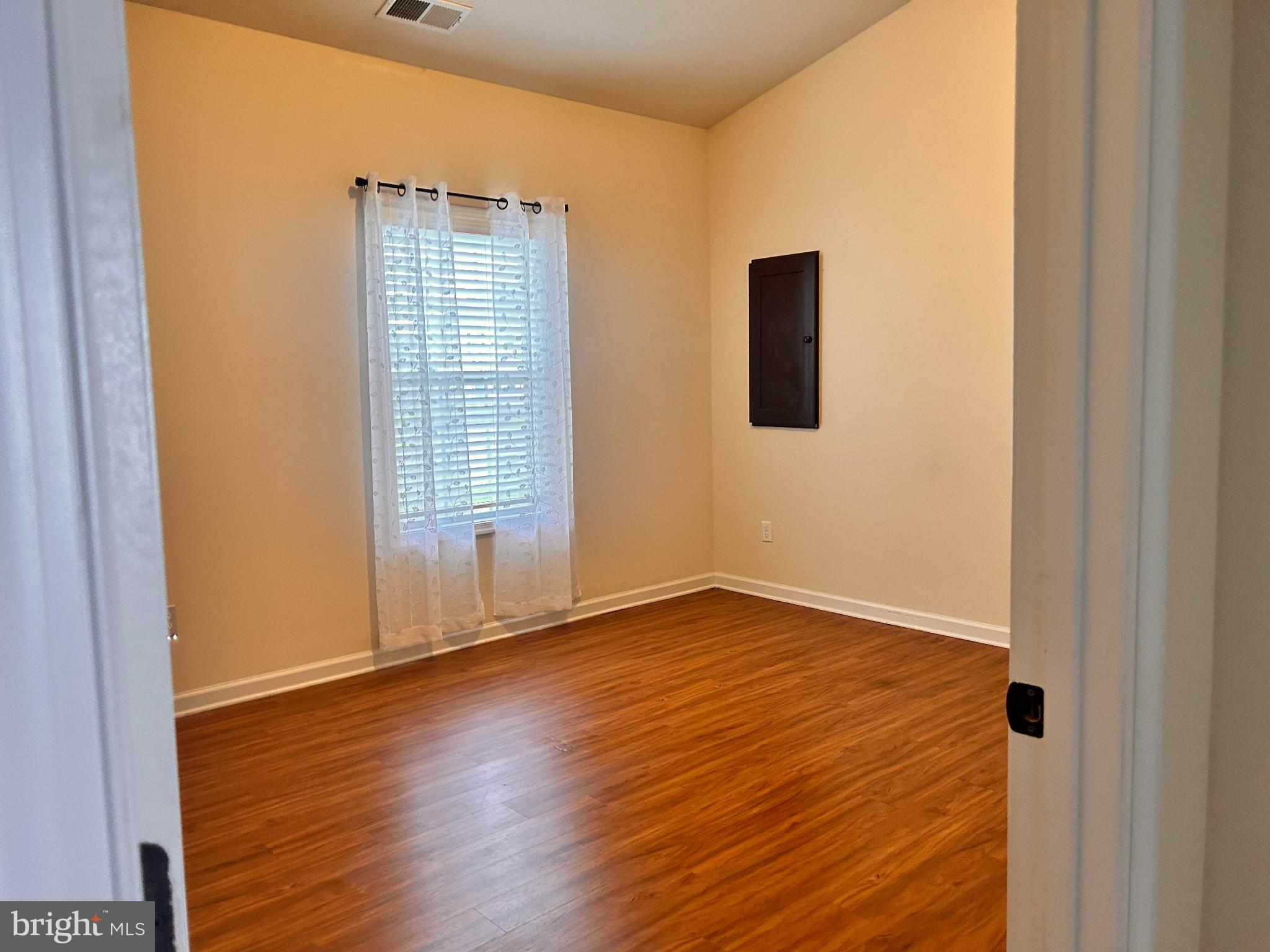 52 Harness Race Road Martinsburg, WV 25404 - Photo 9 of 16 a view of an empty room with wooden floor and a window
