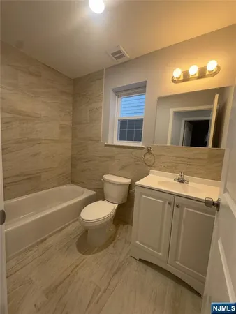 a bathroom with a sink a toilet and bathtub