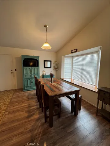 a room with a table chairs and a wooden floor