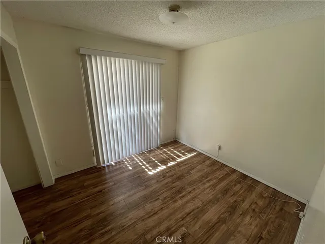 a view of wooden floor and windows in a room