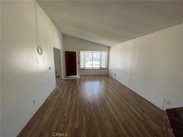 a view of wooden floor and windows in an empty room