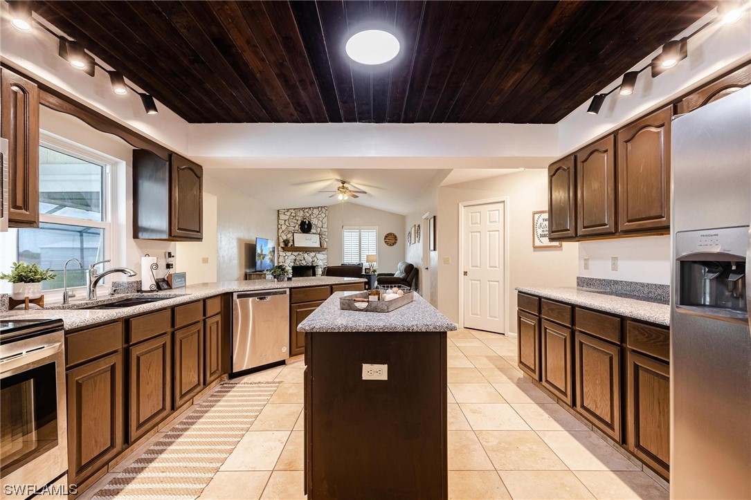 1367 Frontier Circle LaBelle, FL 33935 - Photo 13 of 37 a kitchen with stainless steel appliances granite countertop a sink stove and refrigerator