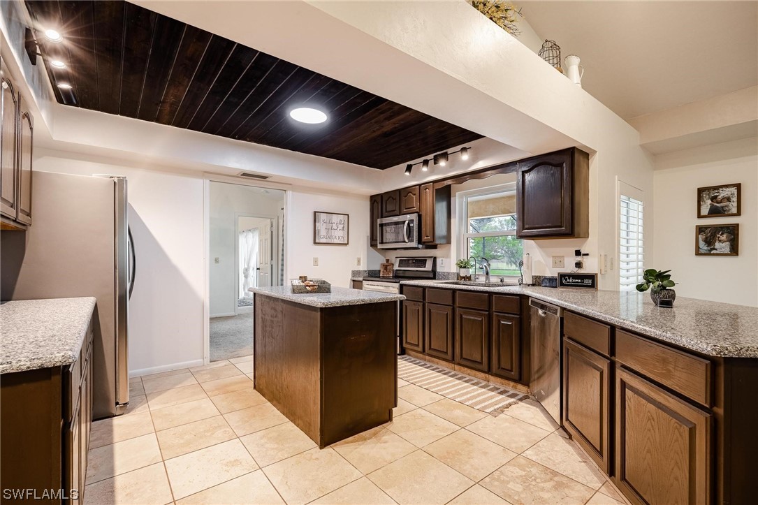 1367 Frontier Circle LaBelle, FL 33935 - Photo 16 of 37 a kitchen with stainless steel appliances kitchen island granite countertop a sink and cabinets