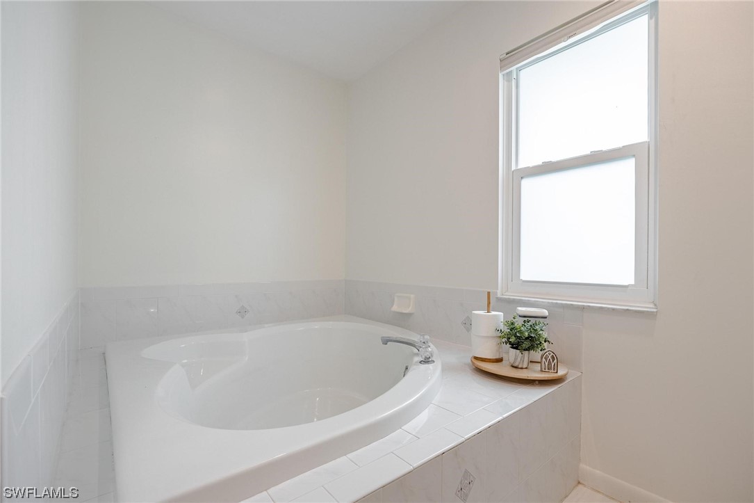 1367 Frontier Circle LaBelle, FL 33935 - Photo 21 of 37 a white bath tub sitting next to a window