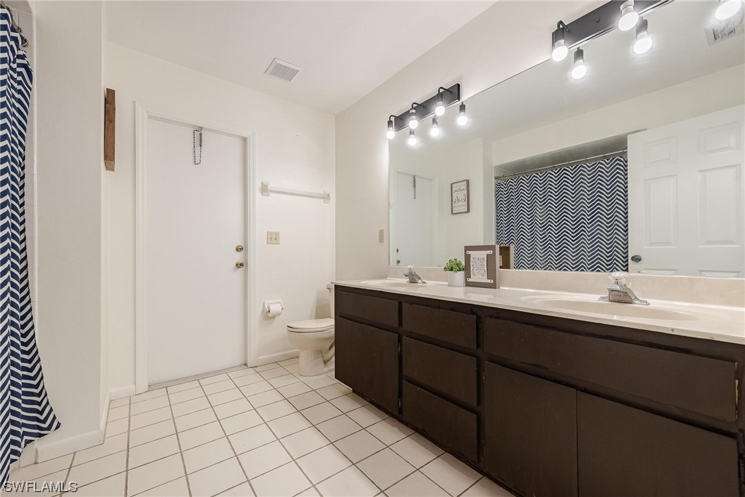 1367 Frontier Circle LaBelle, FL 33935 - Photo 26 of 37 a bathroom with a double vanity sink mirror and toilet