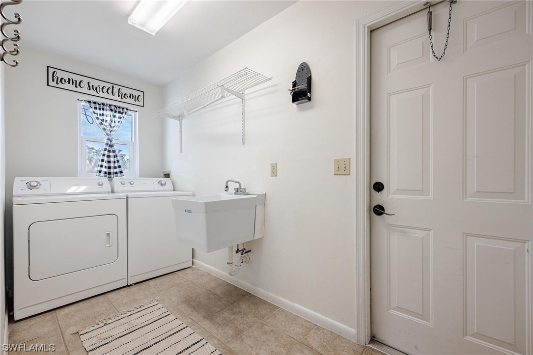 1367 Frontier Circle LaBelle, FL 33935 - Photo 27 of 37 a bathroom with a double vanity sink a mirror and shower