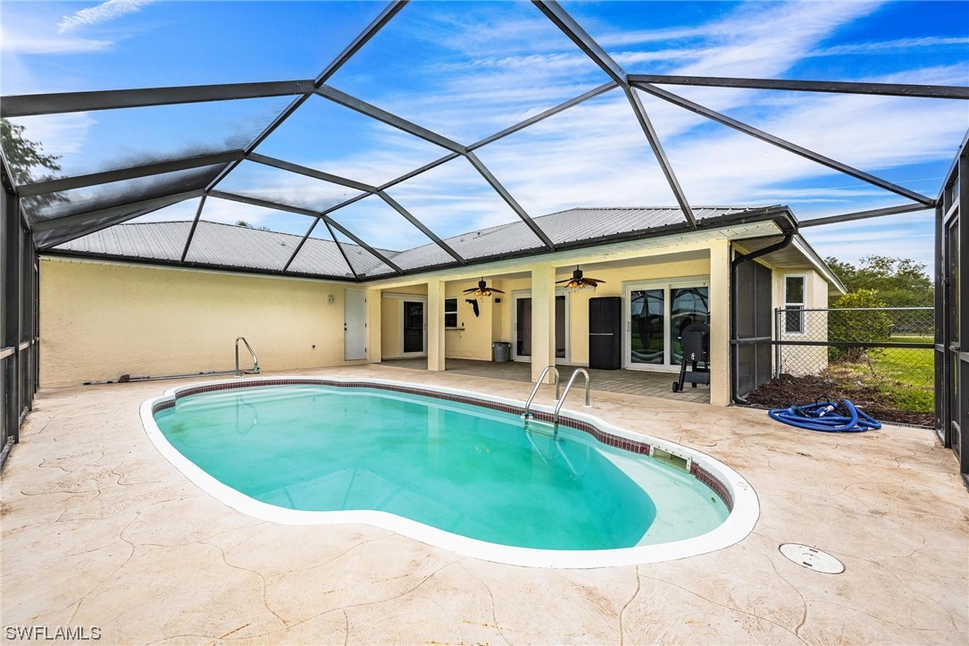 1367 Frontier Circle LaBelle, FL 33935 - Photo 31 of 37 a view of a swimming pool with an outdoor seating