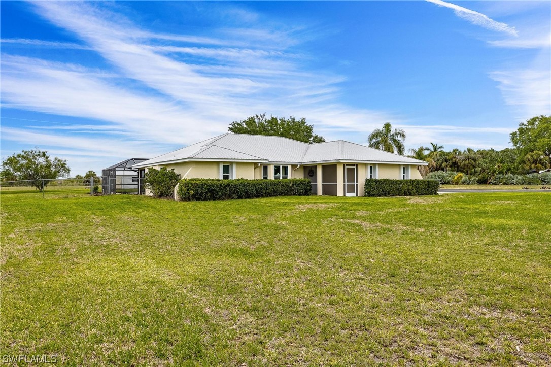 1367 Frontier Circle LaBelle, FL 33935 - Photo 33 of 37 a front view of a house with garden