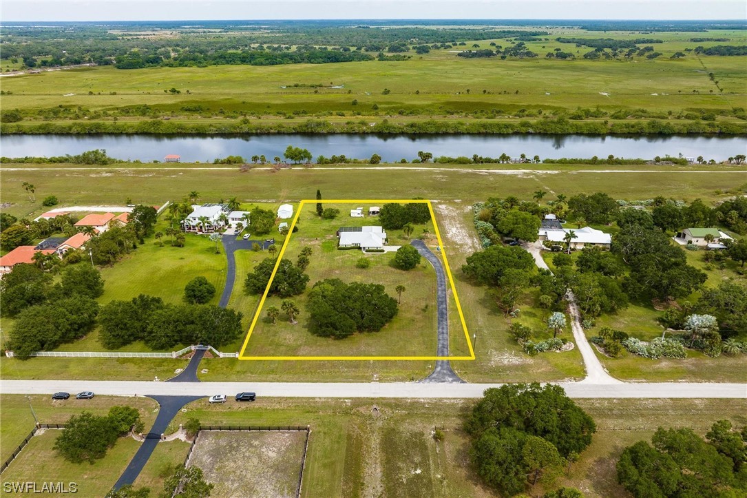 1367 Frontier Circle LaBelle, FL 33935 - Photo 34 of 37 a view of a lake with a houses