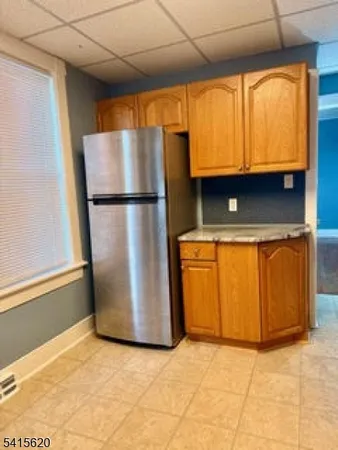 a view of a refrigerator in a kitchen