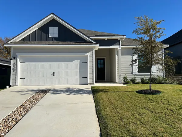 a front view of a house with a yard