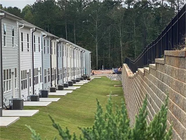 a view of a swimming pool with patio and garden