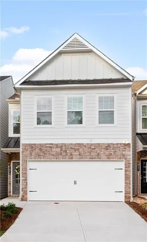 a view of a white house with large windows