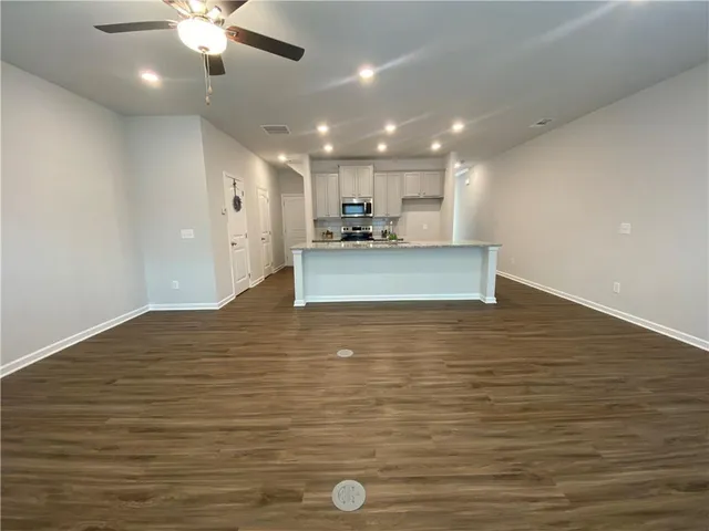 a view of kitchen and empty room