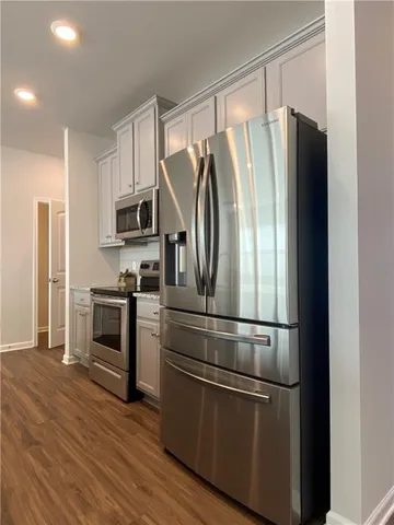 a metallic refrigerator freezer sitting in a kitchen