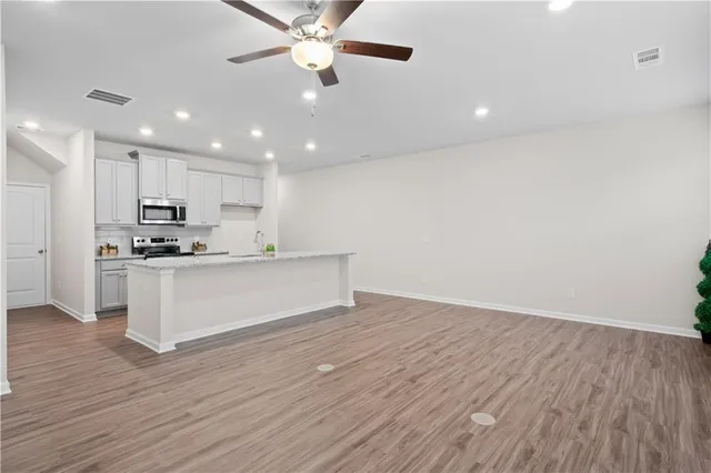 a view of kitchen with granite countertop cabinets and wooden floor