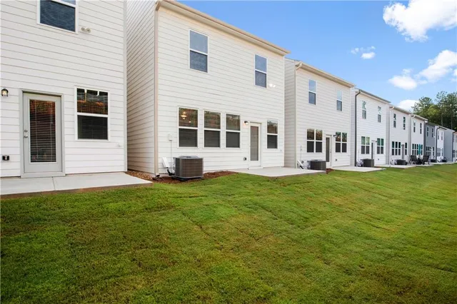 a view of a house with a backyard