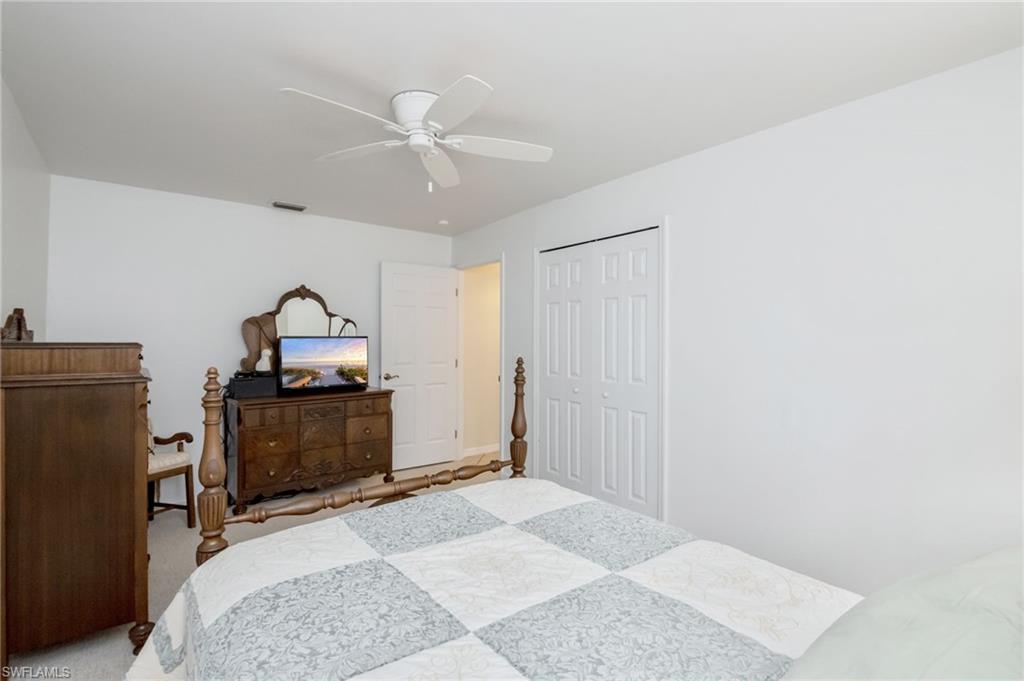 2910 2nd Street Northeast Naples, FL 34120 - Photo 14 of 36 a bedroom with a bed and a dresser