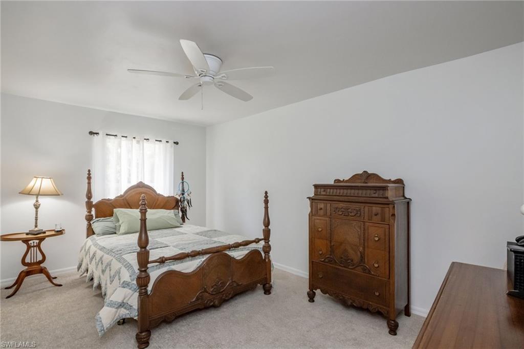 2910 2nd Street Northeast Naples, FL 34120 - Photo 15 of 36 a bedroom with a bed and a lamp on the table