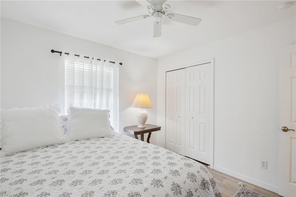 2910 2nd Street Northeast Naples, FL 34120 - Photo 17 of 36 a bedroom with a bed and a chandelier