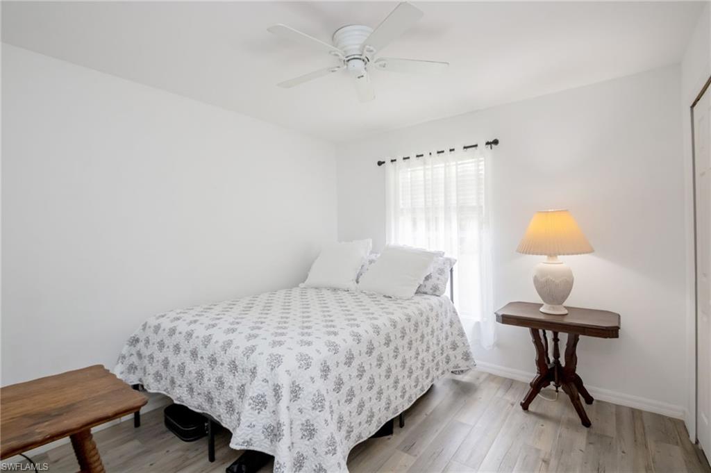 2910 2nd Street Northeast Naples, FL 34120 - Photo 18 of 36 a bedroom with a bed and a table in it