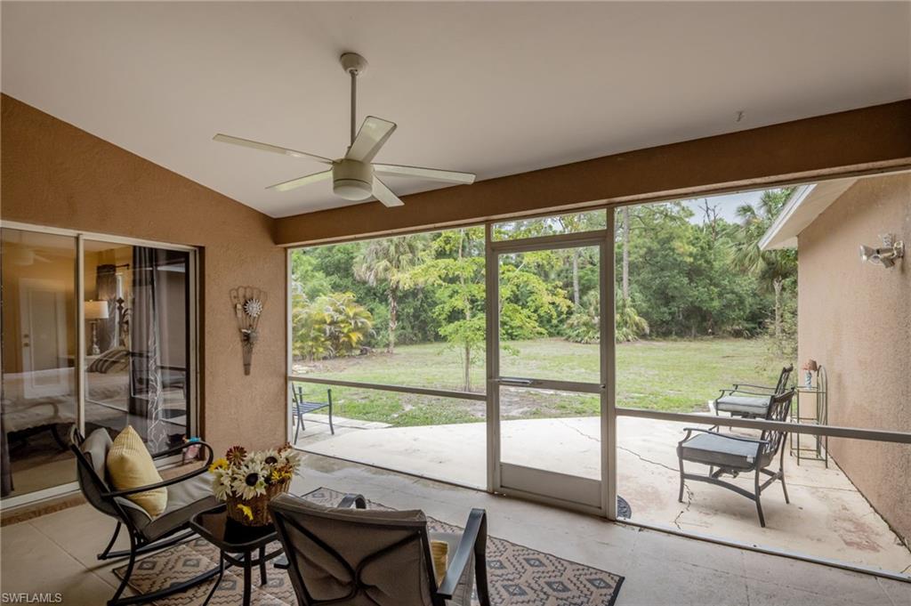 2910 2nd Street Northeast Naples, FL 34120 - Photo 25 of 36 a living room with furniture and a floor to ceiling window