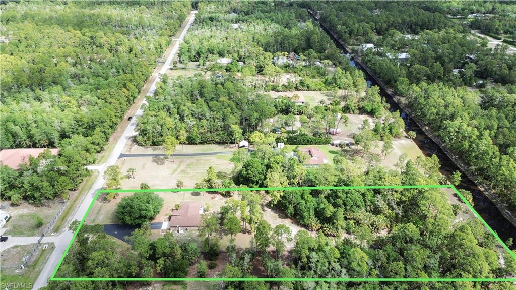 2910 2nd Street Northeast Naples, FL 34120 - Photo 3 of 36 an aerial view of residential house with outdoor space and trees all around