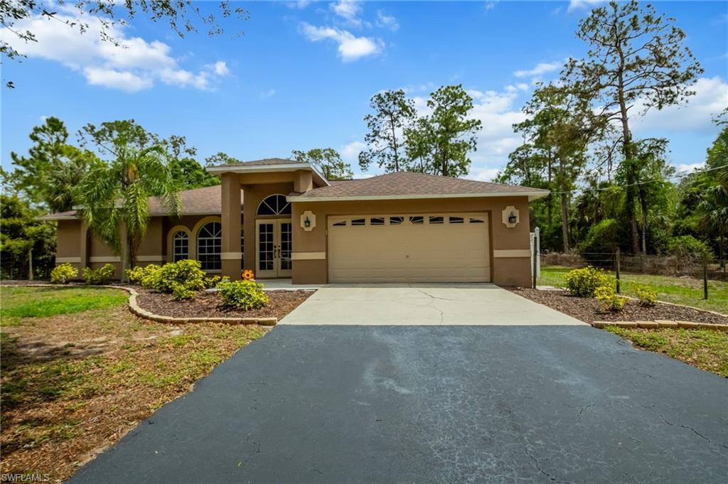 2910 2nd Street Northeast Naples, FL 34120 - Photo 5 of 36 a front view of a house with garden